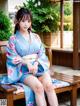 A woman in a blue kimono sitting on a wooden bench.