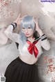 A woman in a sailor outfit posing for a picture.