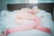 A woman in pink stockings laying on a bed.