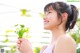 A woman holding a flower in her hand. 
